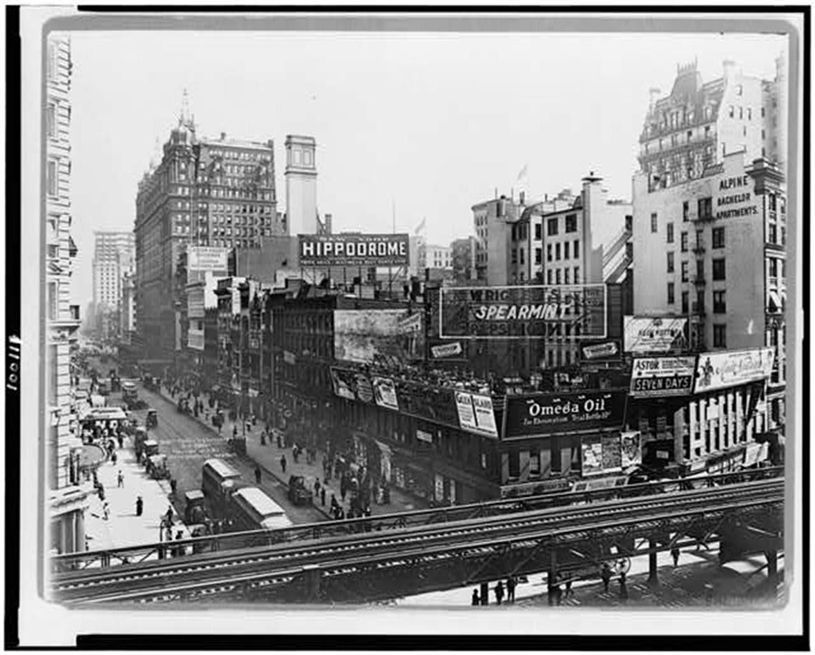 A black and white photograph of New York City billboards and illuminated ads in the early 19th century
