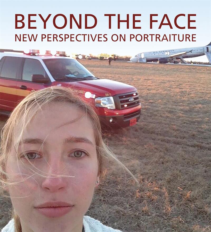 The cover of the book featuring a photograph of a woman, taken via selfie, standing in a field in front of an emergency vehicle. In the background you can see a plane that has landed in the field.