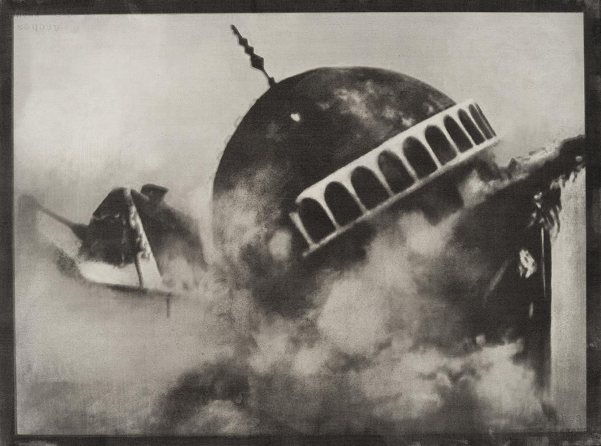 a black and white photograph of a falling building