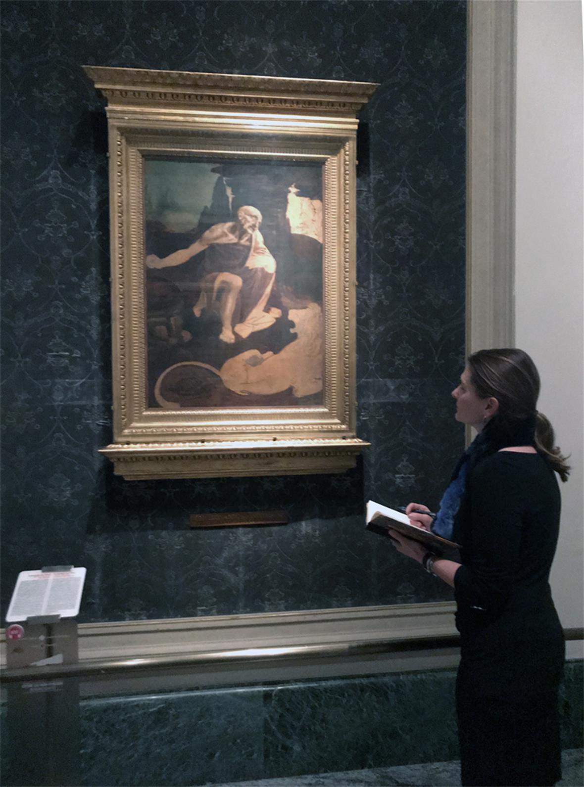 woman looking at a painting indoors