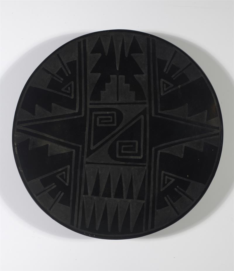 Black plate with geometric pattern.