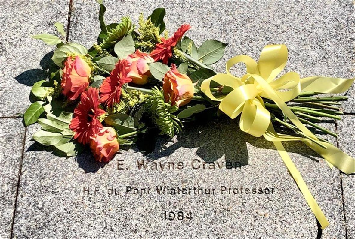 A bouquet of coral-colored roses lay above Wayne Craven's brick in Mentors' Circle.