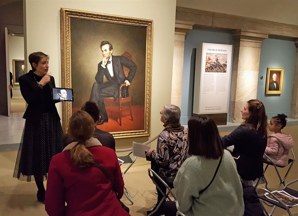 Alba Campo Rosillo speaks to a sitting audience in front of "Abraham Lincoln."
