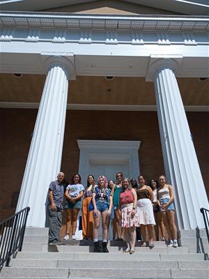 students standing in a group on exterior building steps